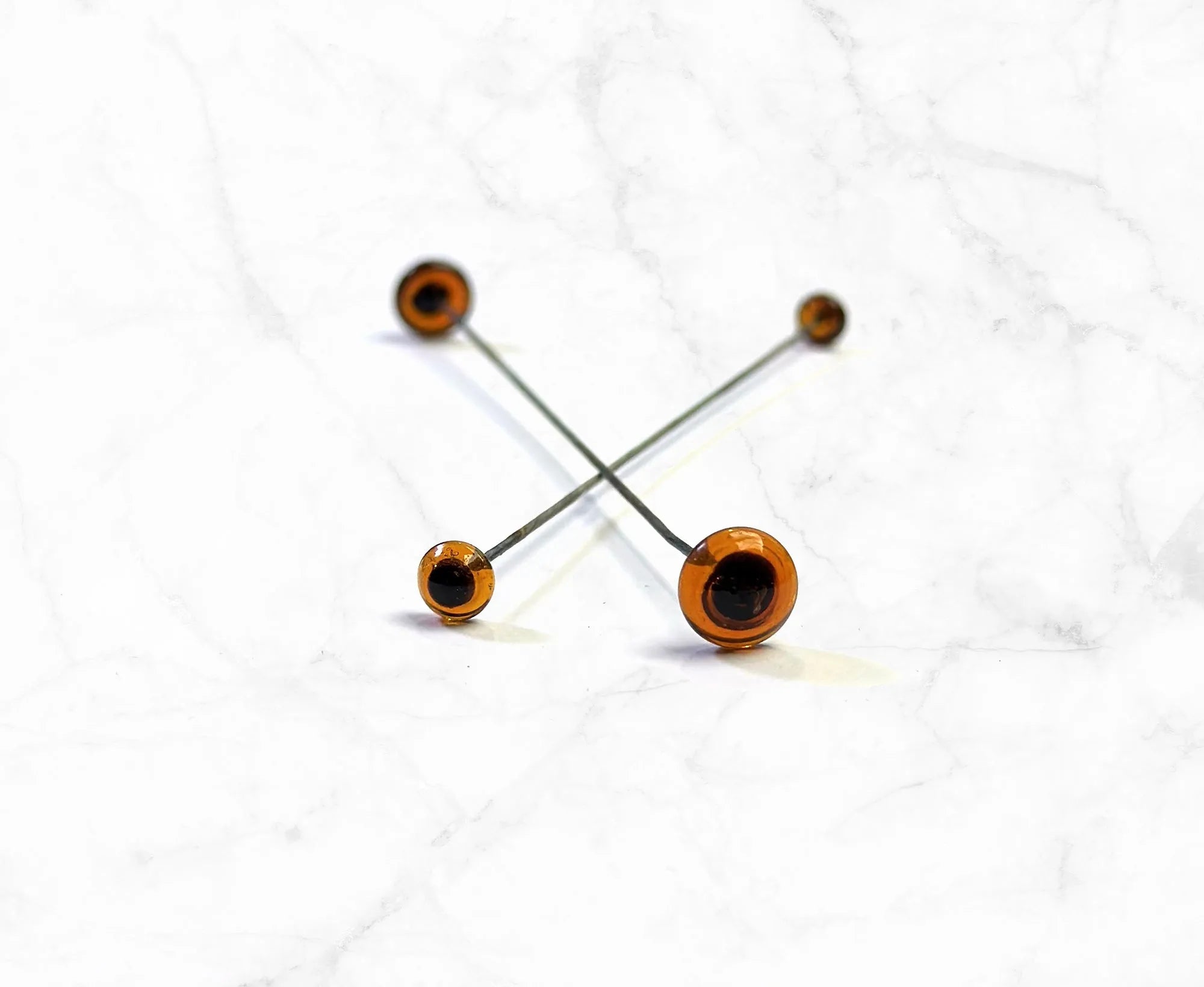 Brown Glass Eyes On Sticks.
